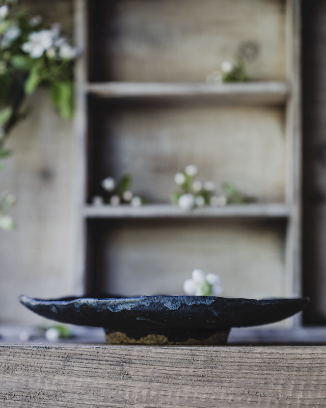 black stoneware footed bowl handmade by clay beehive ceramics