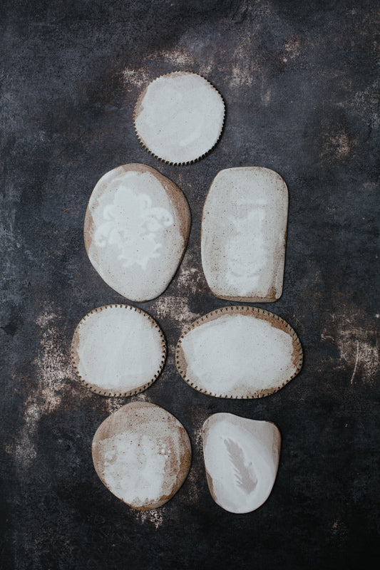 Selection of little plates with warm brown clay and satin white glaze