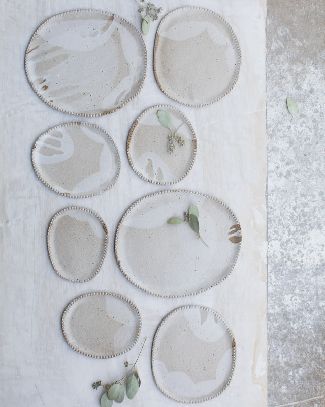 Toasty cafe au lait textured rim oval plates with satin white glaze