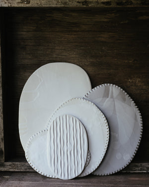 satin white flat plates with textures hand crafted by clay beehive ceramics