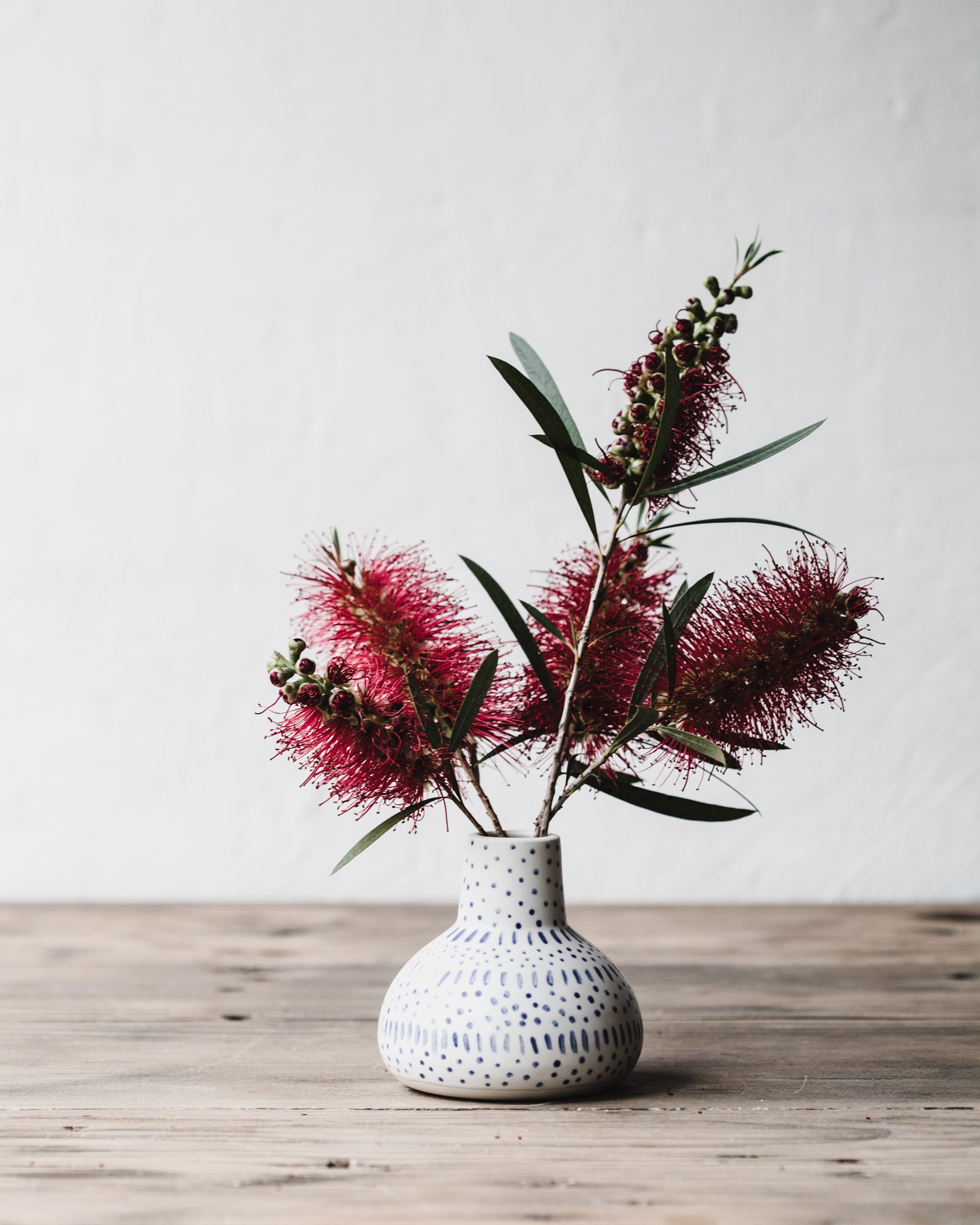 Little wheelthrown bottle necked vase with blue and white patterns