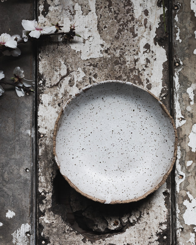 Rustic speckled white bowl with organic shaped rim