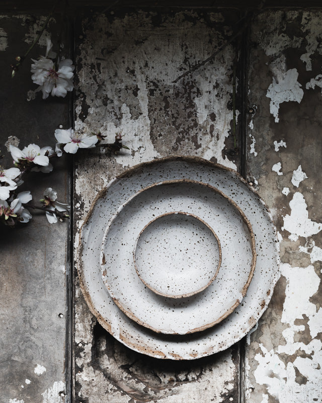 Rustic speckled white bowl with organic shaped rim