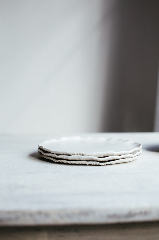 Satin white cake plates with an elegant rim